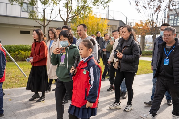 昆山市小學(xué)生在向參觀者介紹“海綿校園”。昆山市住建局供圖